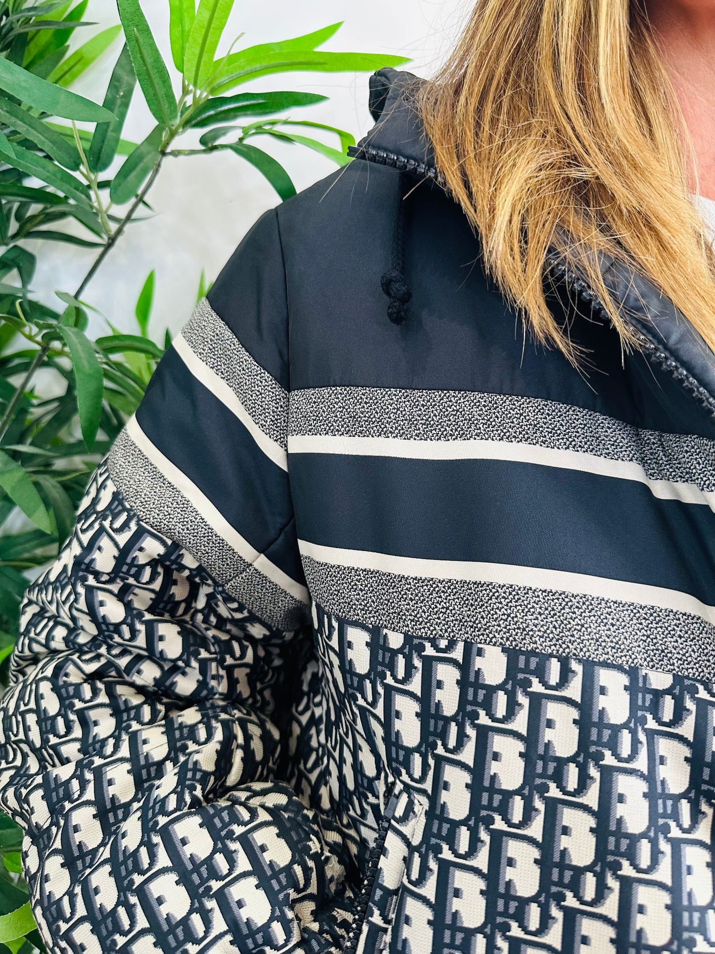 Close-up of a person wearing a Christian Dior patterned jacket 